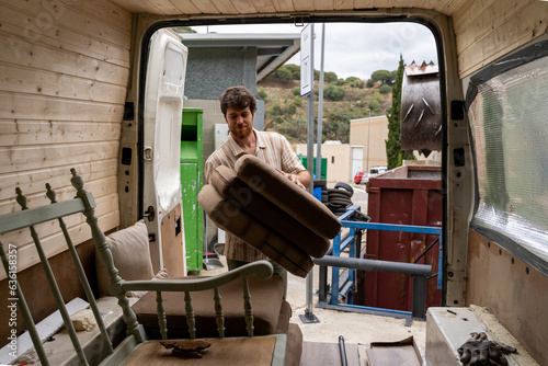 Man dumping furniture at recycling clean point photo