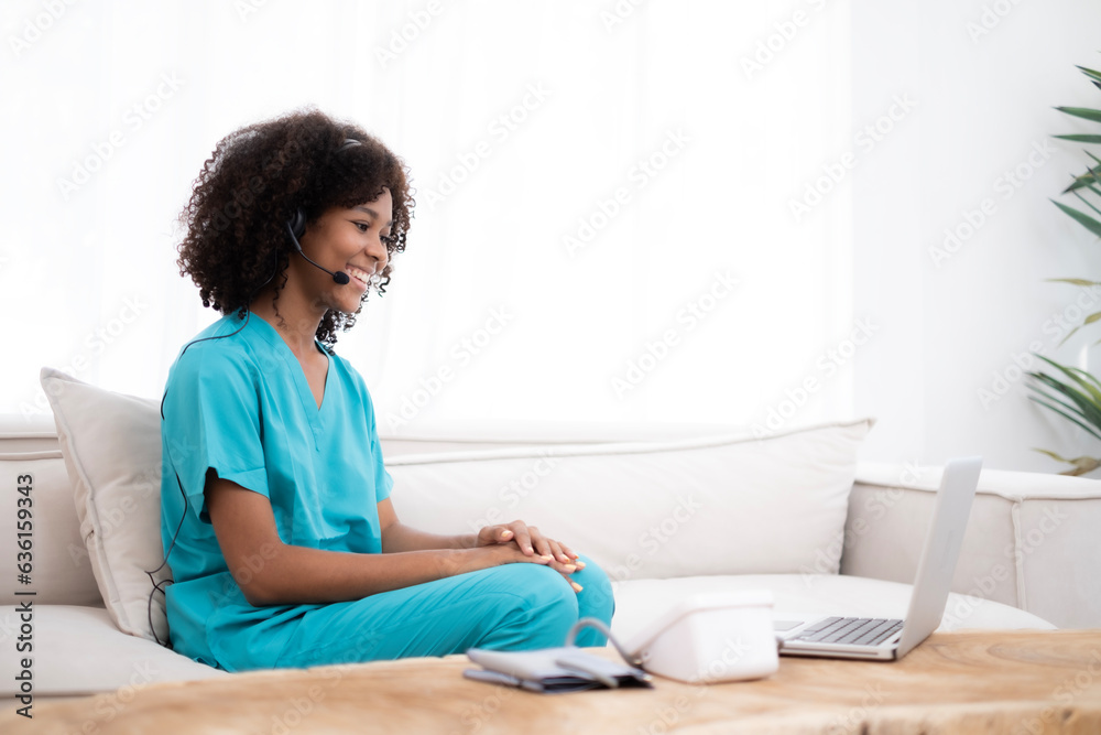 African American doctor taking with smile, wearing green coat, doctor make video call interact through internet talk with patient provide help online counseling and therapy concept. African American doctor taking with smile, wearing green coat, doctor make video call interact through internet talk with patient provide help online counseling and therapy concept.