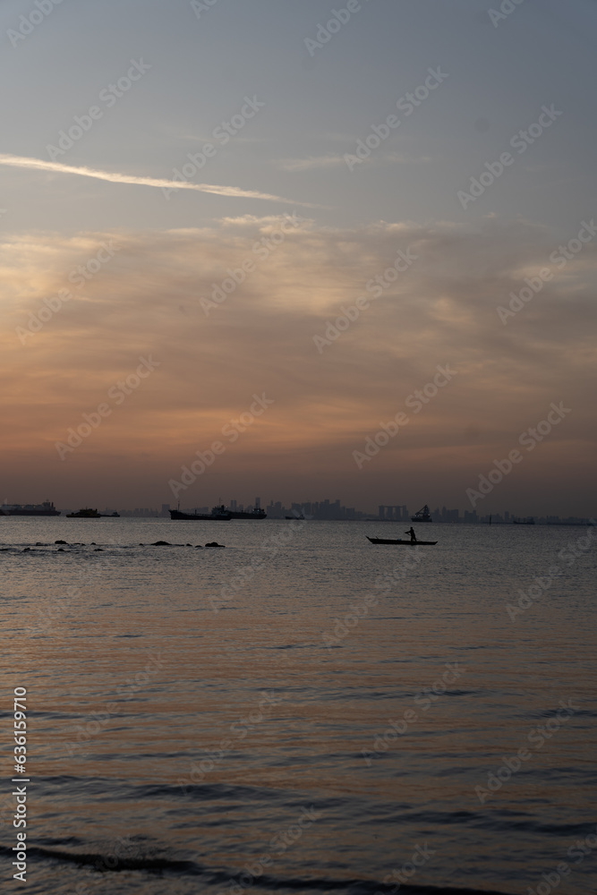 Sunset on a beach in Indonesia. Colorful sky, warm colors, natural daylight. Sunset on a beach in Indonesia. Colorful sky, warm colors, natural daylight.