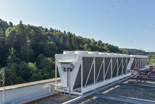 double stack dry cooler on a roof next to a forest with blue sky - hot or cool fluid and air exchange system