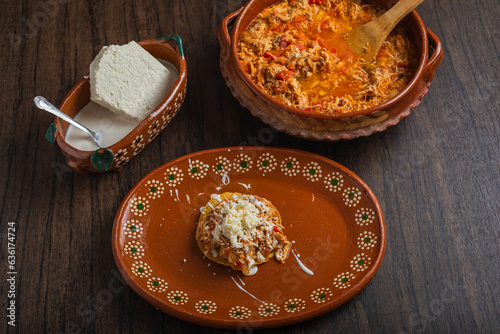 Authentic mexican chicken tinga with fresh cheese and cream on toast. photo