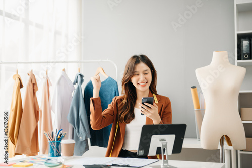 Fotografi Diverse female fashion designers at work with tailor centimeters on necks and holds tablet and smartphone