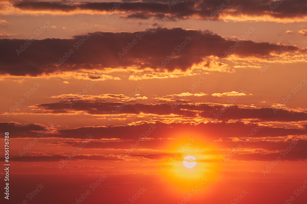 Fototapeta premium The evening sky was a canvas of oranges and reds, reflecting the fading light.