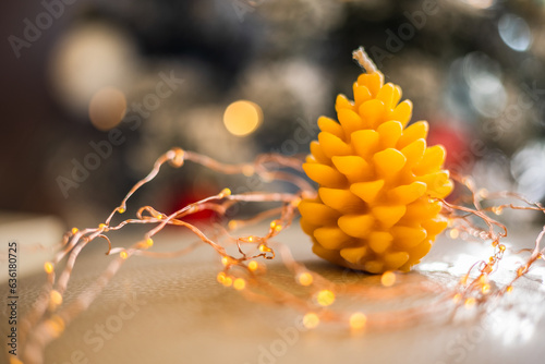 close up pine cone candle on christmas background