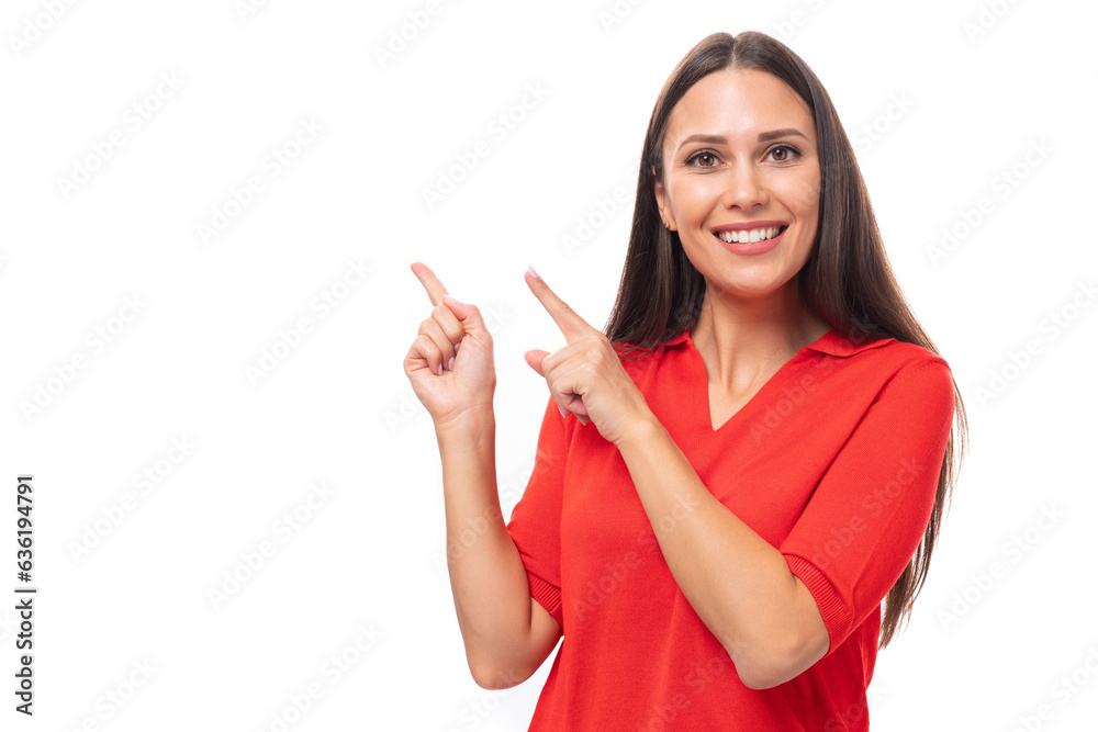 young european woman with black hair dressed in a red t-shirt shows empty space on the wall young european woman with black hair dressed in a red t-shirt shows empty space on the wall
