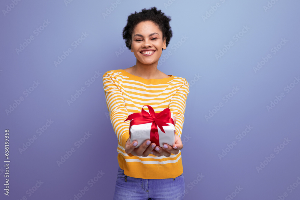 happy afro brunette 20s latin young woman holding out gift box happy afro brunette 20s latin young woman holding out gift box