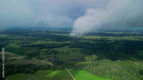 Aerial dolly to wispy clouds casting shadows on farmland photo