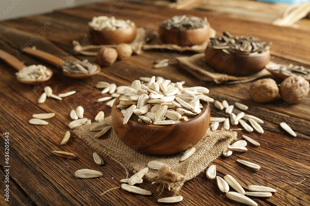 Fototapeta premium DRİED NUTS AND FRUİTS IN WOODEN BOWL ON BROWN FLOOR