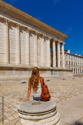 Nimes city in France, Traveler or student sitting in maison carrée square photo