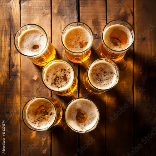 Top down view of mugs or beer served in a glass and sat on a rustic wooden table. Oktober fest or drinking and alcohold problems concept. 