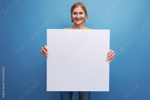 smiling blonde mature woman holding note board with mocap