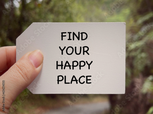 Traveling inspirational and motivational quotes. Find Your Happy Place written on white paper. Blurred styled background. © Coompia77