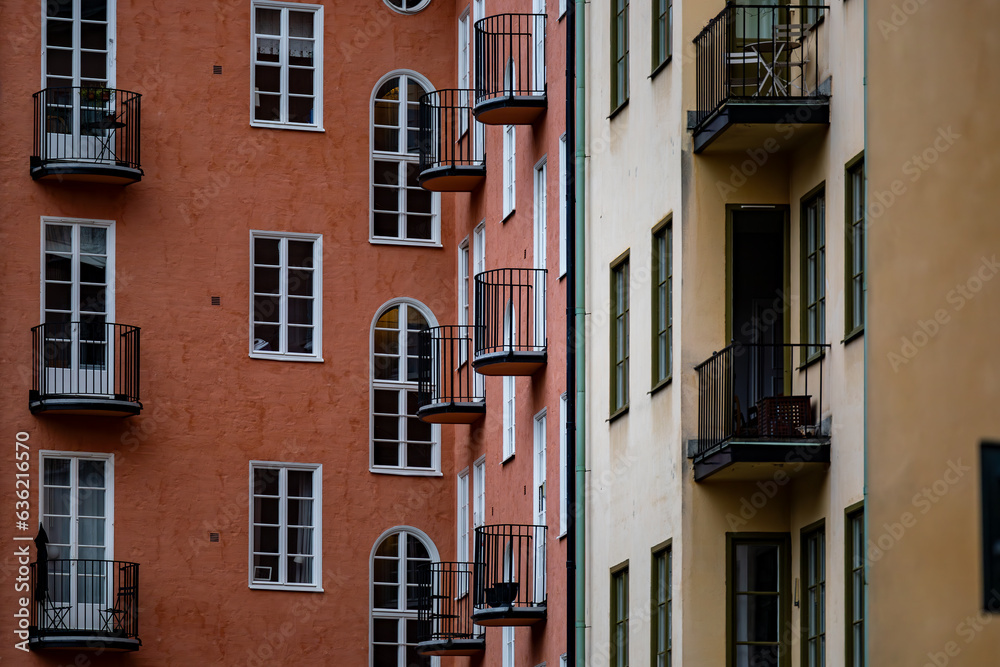 Stockholm, Sweden A classic residential building courtyard with windows and balconies in orange and yellow.