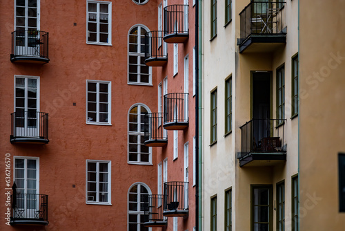 Stockholm, Sweden A classic residential building courtyard with windows and balconies in orange and yellow.