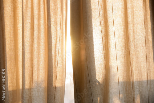 Sunlight breaking through curtains, summertime, golden hour time	