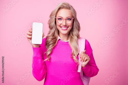Photo of gorgeous girl wavy hairstyle dressed stylish clothes hand showing phone empty space qr code isolated on pink color background