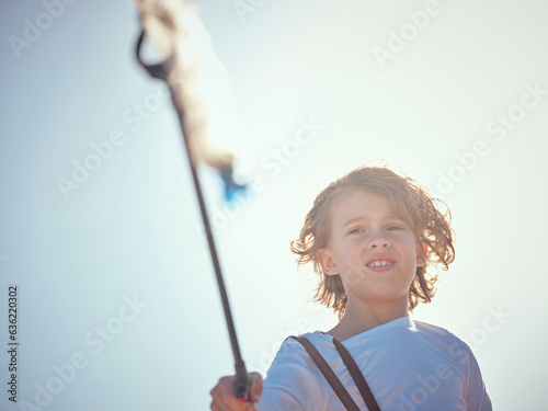 Cute preteen boy with trash grabber and plastic bottle
