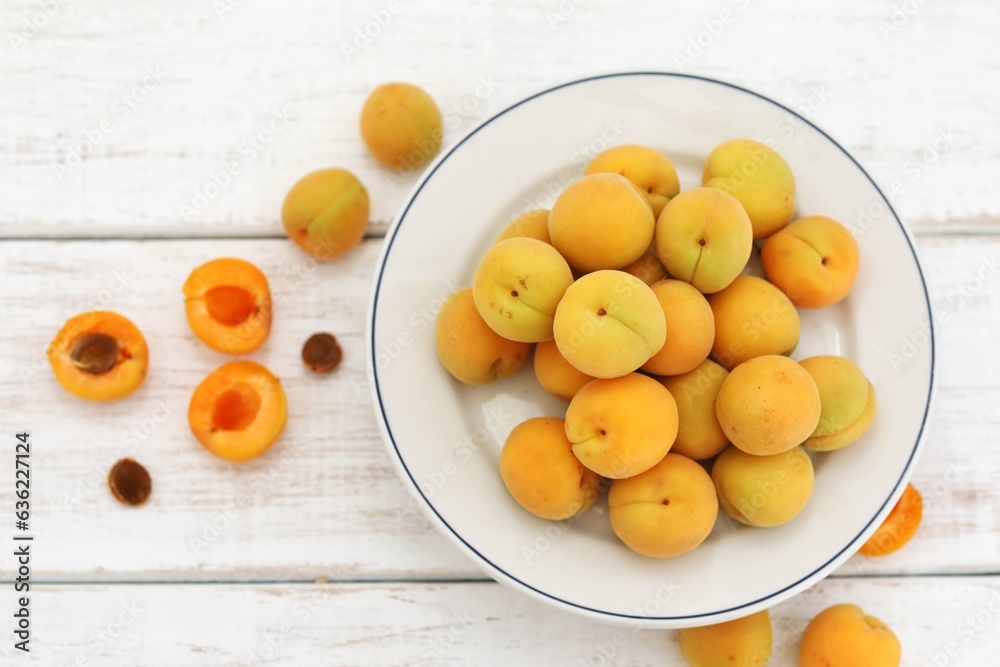 Apricots, still life, fresh fruits, on a white wooden table, top view, place for text, free space, background