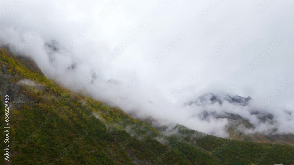 Clouds above the Himalayan mountain peaks of Lahaul Valley in Himachal Pradesh, India during the monsoon season. Clouds above the forest on the mountain in Himachal. Nature background Clouds above the Himalayan mountain peaks of Lahaul Valley in Himachal Pradesh, India during the monsoon season. Clouds above the forest on the mountain in Himachal. Nature background