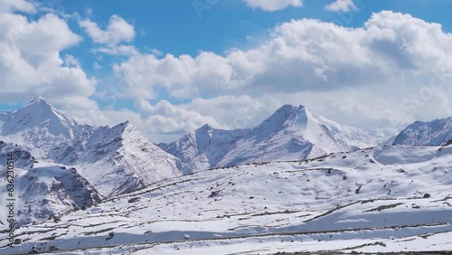 Snow covered Himalyan mountain peak at Shinkula Pass on the way to Zanskar in Himachal Pradesh, India. View of the snow covered mountain during the day in the Himachal. Natural winter background. photo