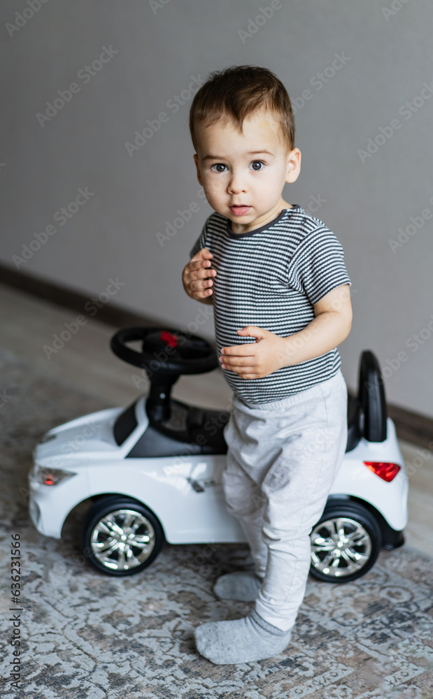 A young boy posing with a toy car A young boy posing with a toy car