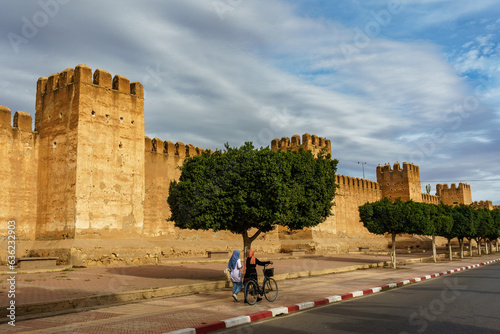 Morocco. Taroudant. Women walking front of the city walls photo