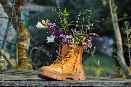 Bright flowers in boot in rural area