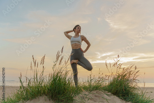 Does the asana pose workout outdoors. A female trainer uses fitness clothes for exercise. Meditation and harmony. A healthy lifestyle is mental health, the life of a modern person.