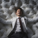 A businessman lies contentedly with his arms outstretched on a bed - sofa, ai generiert
