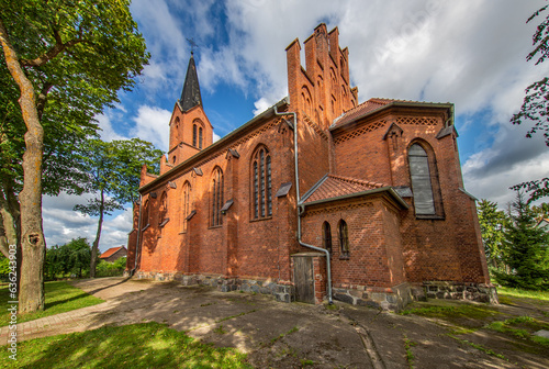 Fototapeta Naklejka Na Ścianę i Meble -  General view and close-up architectural details of the Catholic Church of St. Holy Trinity in the town of Dwawrzuty in Masuria in Poland.