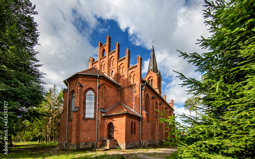 Fototapeta Naklejka Na Ścianę i Meble -  General view and close-up architectural details of the Catholic Church of St. Holy Trinity in the town of Dwawrzuty in Masuria in Poland.