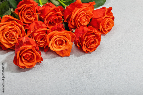 Bouquet of fresh bright roses on light stone background. Romantic gift concept  greeting card