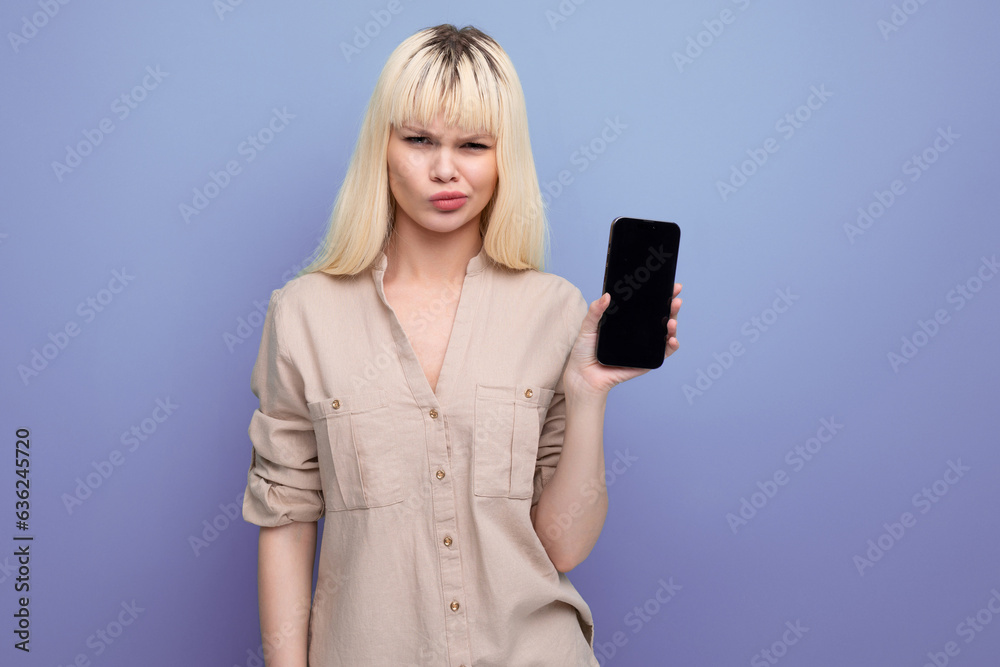 sad upset blonde manager young woman holding smartphone with mockup sad upset blonde manager young woman holding smartphone with mockup