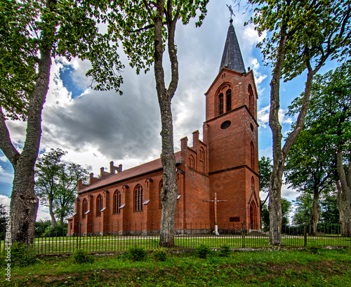 Fototapeta Naklejka Na Ścianę i Meble -  General view and close-up architectural details of the Catholic Church of St. Holy Trinity in the town of Dwawrzuty in Masuria in Poland.