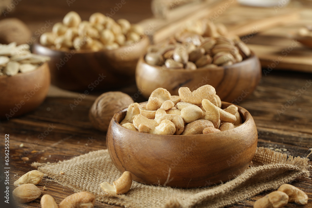 DRİED NUTS AND FRUİTS IN WOODEN BOWL ON BROWN FLOOR DRİED NUTS AND FRUİTS IN WOODEN BOWL ON BROWN FLOOR