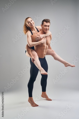 Couple of man and woman having fun during workout in studio