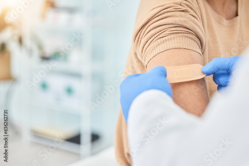 Bandaid, vaccine and arm of patient with doctor for healthcare, medical consultation and bandage for covid injection. Hands, hospital nurse and plaster for an injury, virus or safety while sick