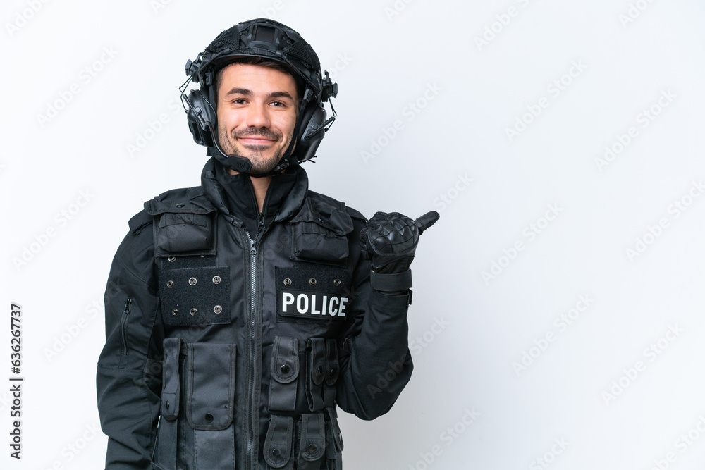 Young caucasian SWAT man isolated on white background pointing to the side to present a product