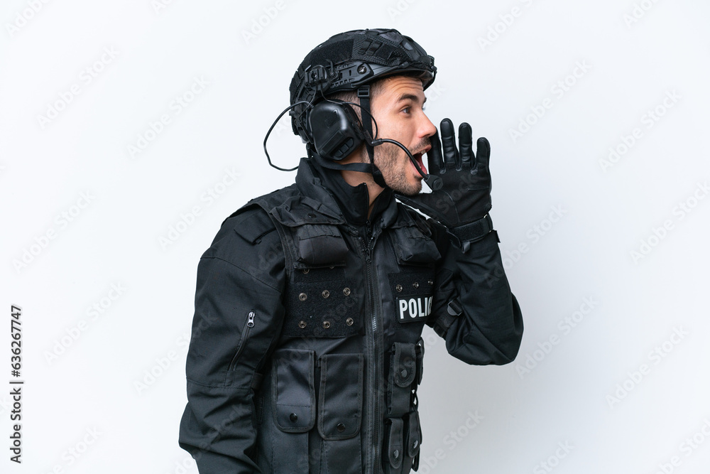 Fototapeta premium Young caucasian SWAT man isolated on white background shouting with mouth wide open to the lateral