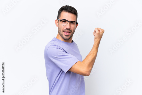Young caucasian man isolated on white background doing strong gesture