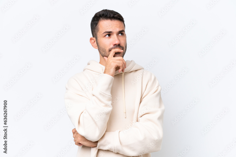 Young caucasian man isolated on white background having doubts and with confuse face expression Young caucasian man isolated on white background having doubts and with confuse face expression