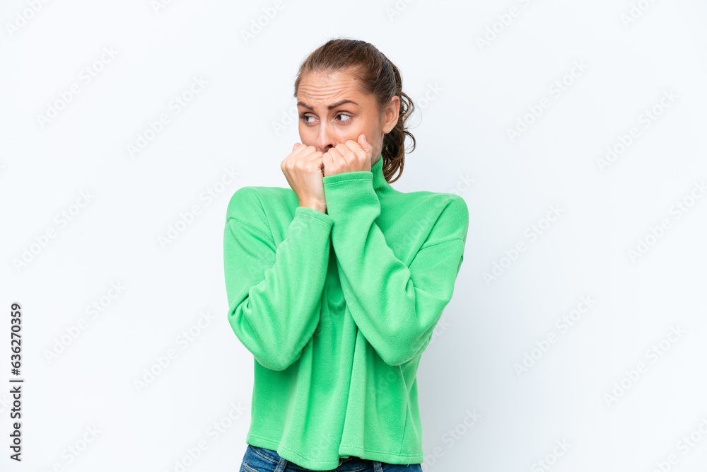 Young caucasian woman isolated on white background nervous and scared putting hands to mouth Young caucasian woman isolated on white background nervous and scared putting hands to mouth