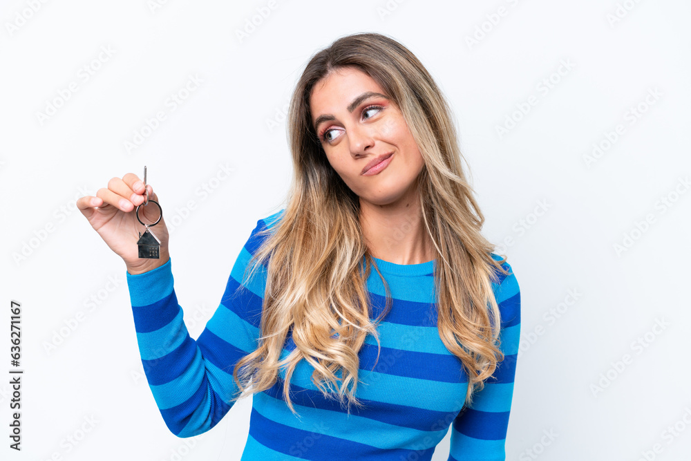 Fototapeta premium Young pretty Uruguayan woman holding home keys isolated on white background with sad expression
