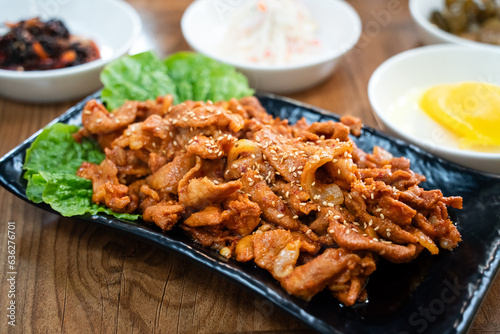 Delicious Korean cuisine jeyuk bokkeum, stir-fried pork in a plate for serving dish. photo