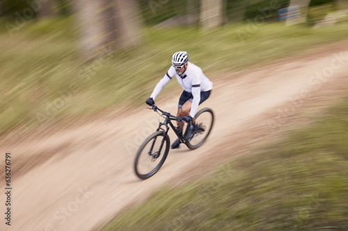 Nature, mountain bike speed and sports man travel, action and ride bicycle for cycling, fitness or exercise. Top view dirt path, fast motion blur and extreme cyclist training for race on forest land