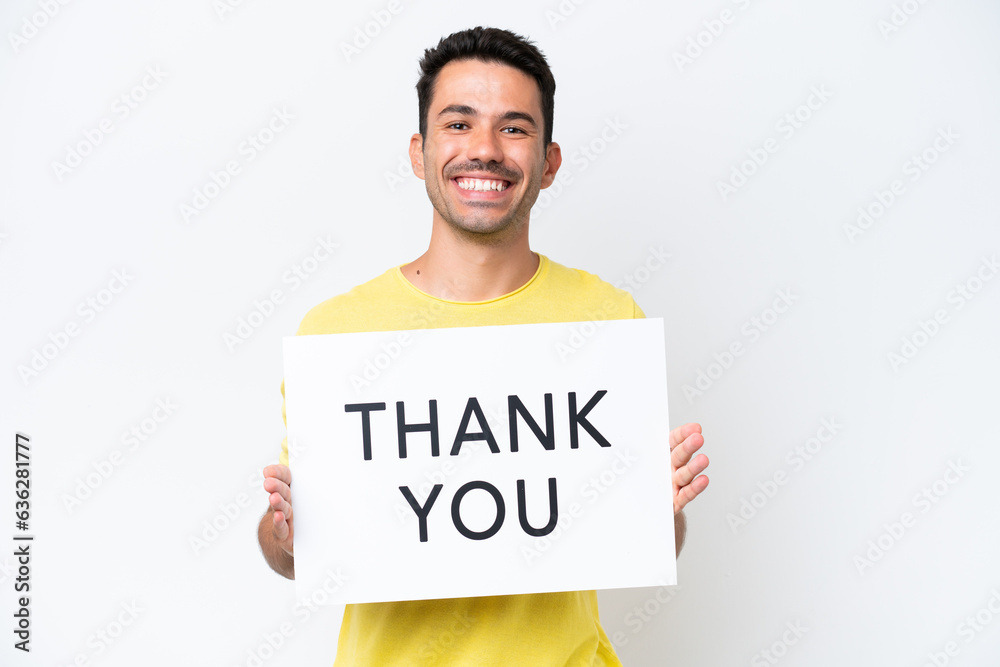 Young handsome man over isolated white background holding a placard with text THANK YOU with happy expression Young handsome man over isolated white background holding a placard with text THANK YOU with happy expression