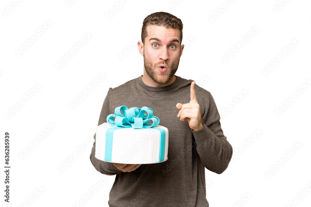 Young handsome blonde man holding birthday cake over isolated chroma key background intending to realizes the solution while lifting a finger up Young handsome blonde man holding birthday cake over isolated chroma key background intending to realizes the solution while lifting a finger up