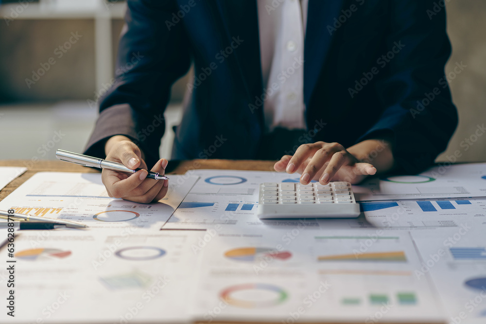 Businessman analyzing investment chart and pressing calculator button to calculate documents Accounting close up image of financial documents on digital tablet Businessman analyzing investment chart and pressing calculator button to calculate documents Accounting close up image of financial documents on digital tablet