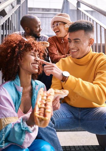 Hotdog  friends and people eating outdoor for travel  funny laugh and fun on stairs. Diversity  happiness and gen z group of men and women with food on date  adventure and touch nose in urban town