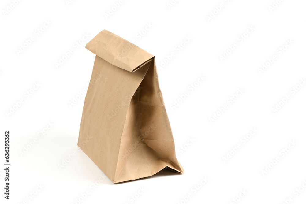 Close and full paper disposable bag of brown kraft paper isolated on white background. Close and full paper disposable bag of brown kraft paper isolated on white background.